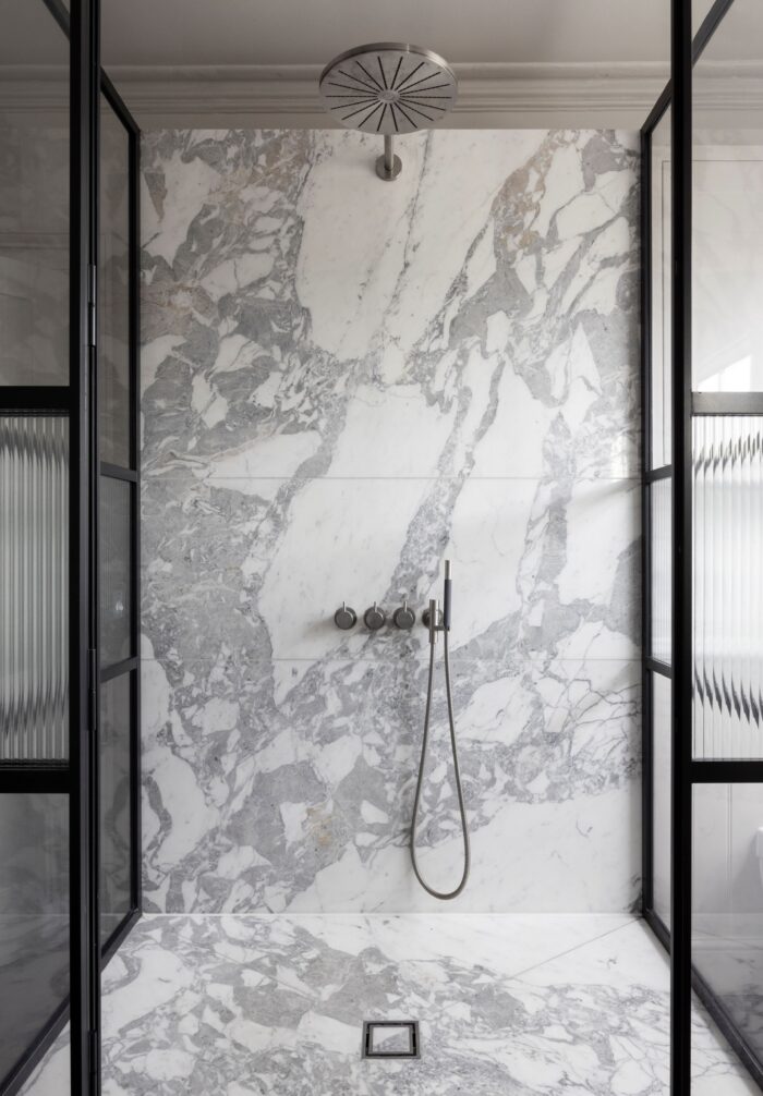 The marble in the new ensuite bathroom is Carrarra, which matches the existing marble fireplaces in the home.