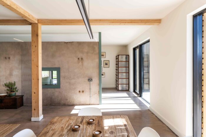 This re-used concrete panel was in the original barn and now acts as both a room separator between the living and dining areas and also as a heat sink, a key sustainable barn conversion feature.