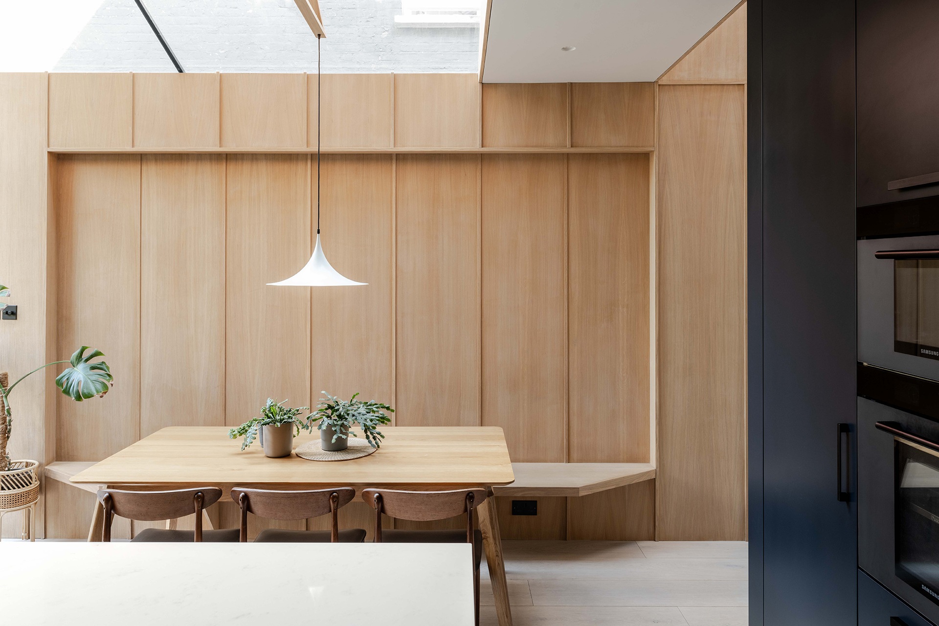 The new extension featuring dining table and oak wall panelling 
