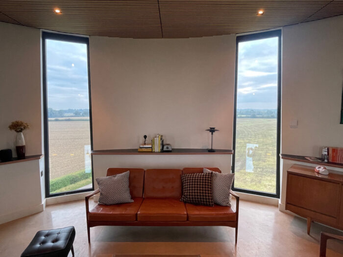 Sofa in the living room at the tower with two windows behind