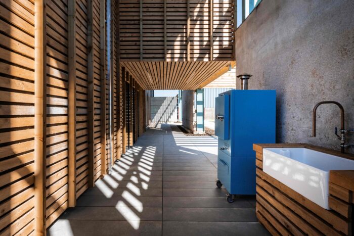This outdoor kitchen is a favourite space for former chef Chris. The kitchen is in a hybrid space between the house and the exterior walls of the barn