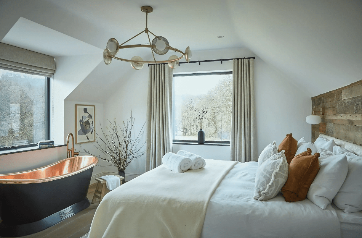 The master bedroom suite boasts a copper freestanding bath and views of the fells.